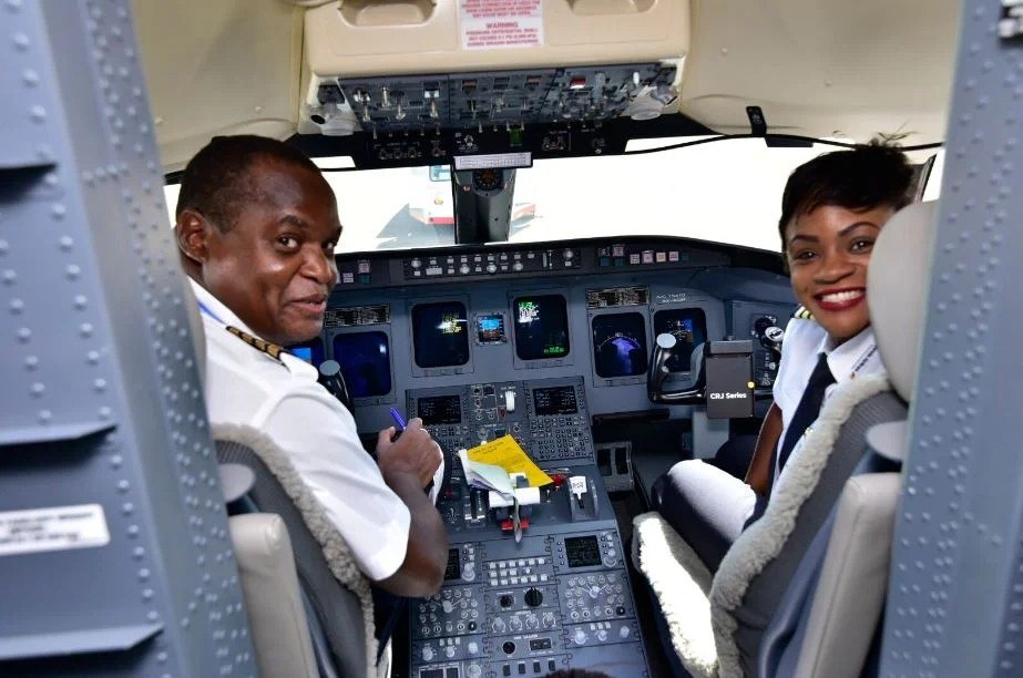 Pilots in the cockpit of a Uganda Airlines CRJ900