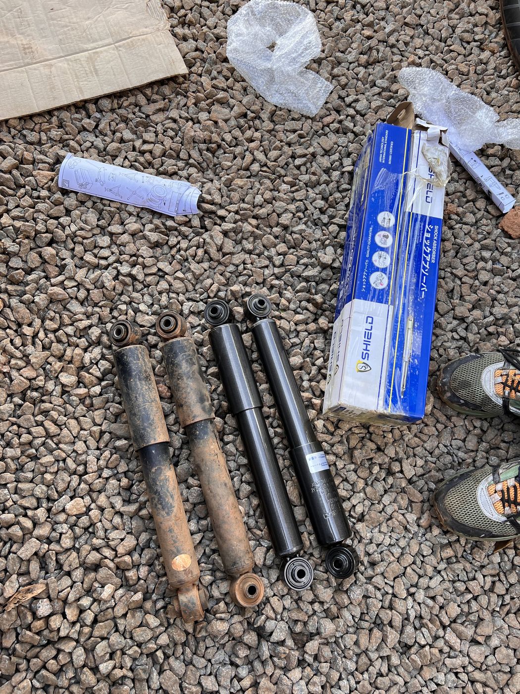 Worn shock absorbers next to new genuine SHIELD replacements at Makanga Auto Centre