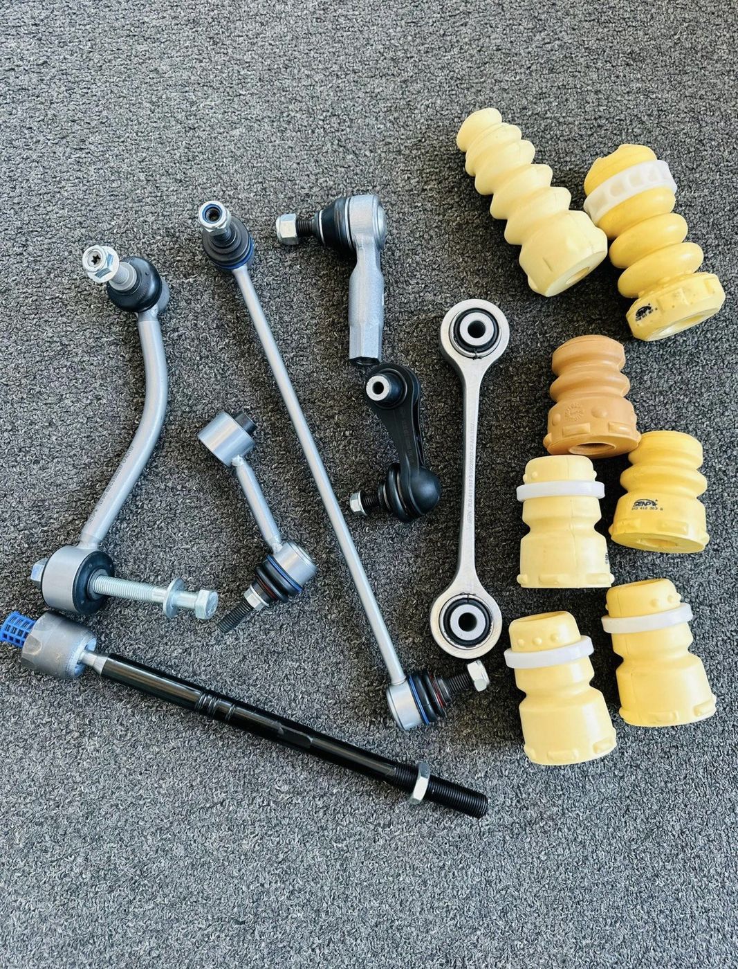 Genuine suspension and steering parts — control arms, tie rods, sway bar links and shock mounts — stocked for general repairs and maintenance at Makanga Auto Centre