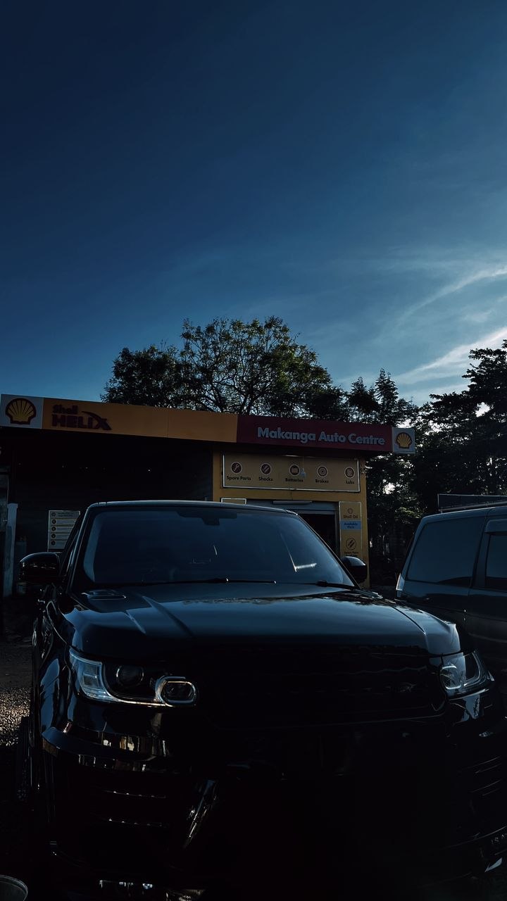 Washed and polished Range Rover outside Makanga Auto Centre at dusk